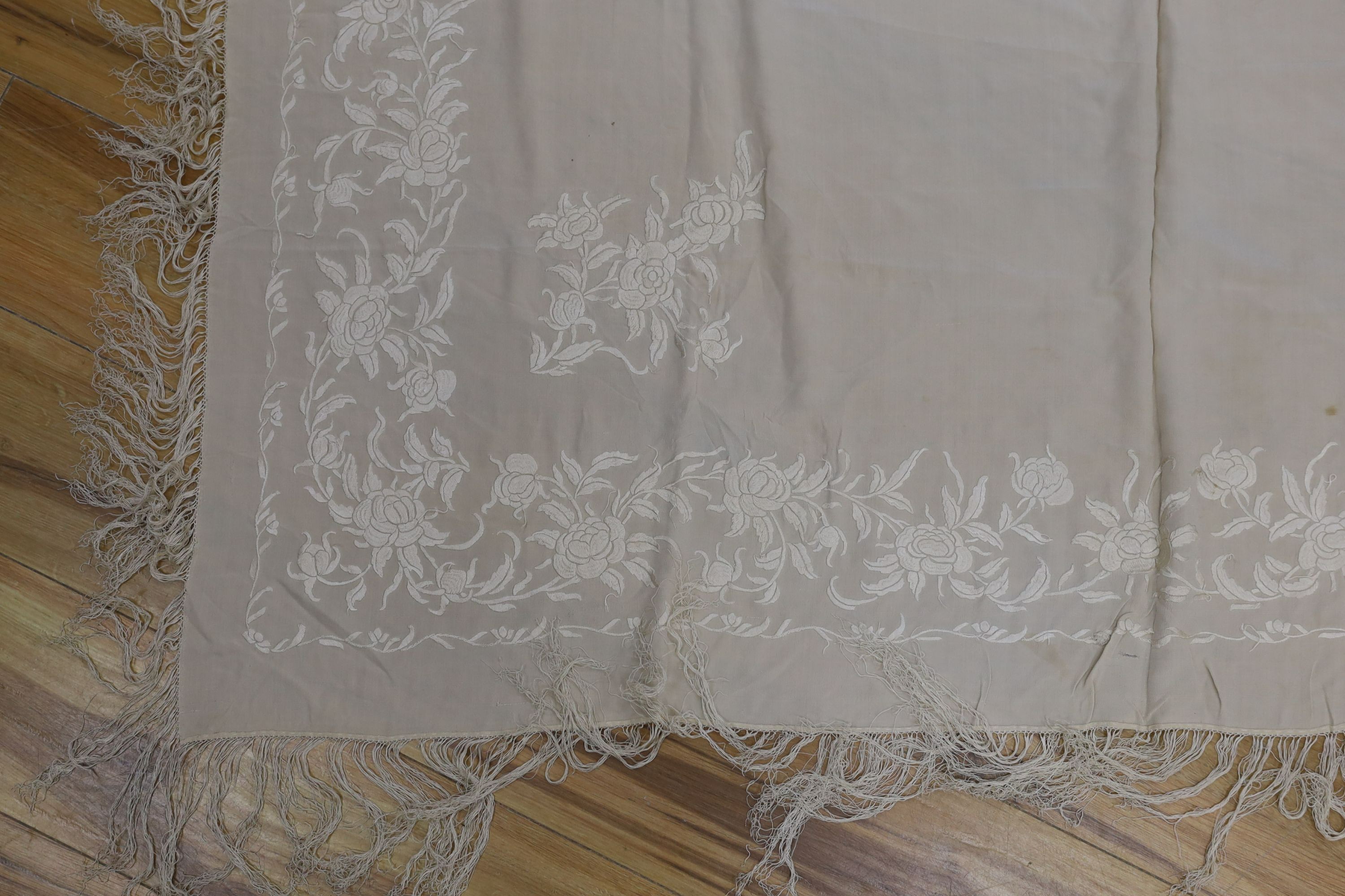 A 19th century cream embroidery on cream silk shawl together with a smaller later shawl